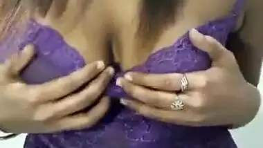 Krisha in violet top pressing her boob and talking